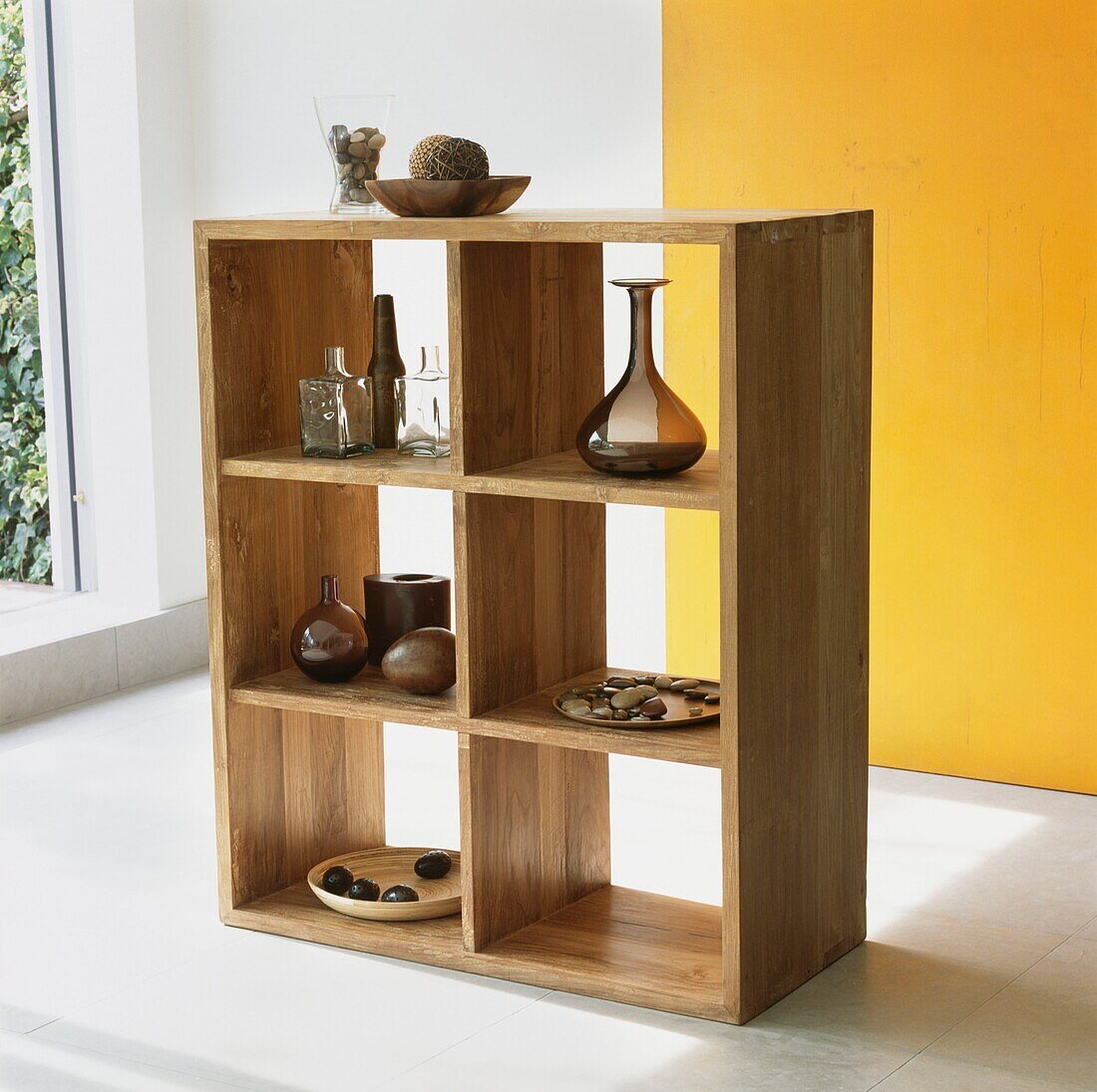 Freestanding wooden shelving unit with ornaments