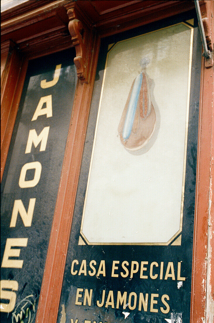 Painted sign outside a delicatessen of cured meats in Madrid