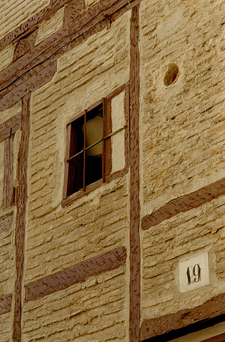 Facade of old timber building showing plaster and brick panels in Segovia
