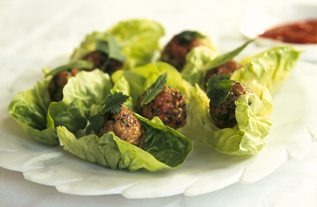 Lettuce wrapped Moroccan meatballs on a white table setting