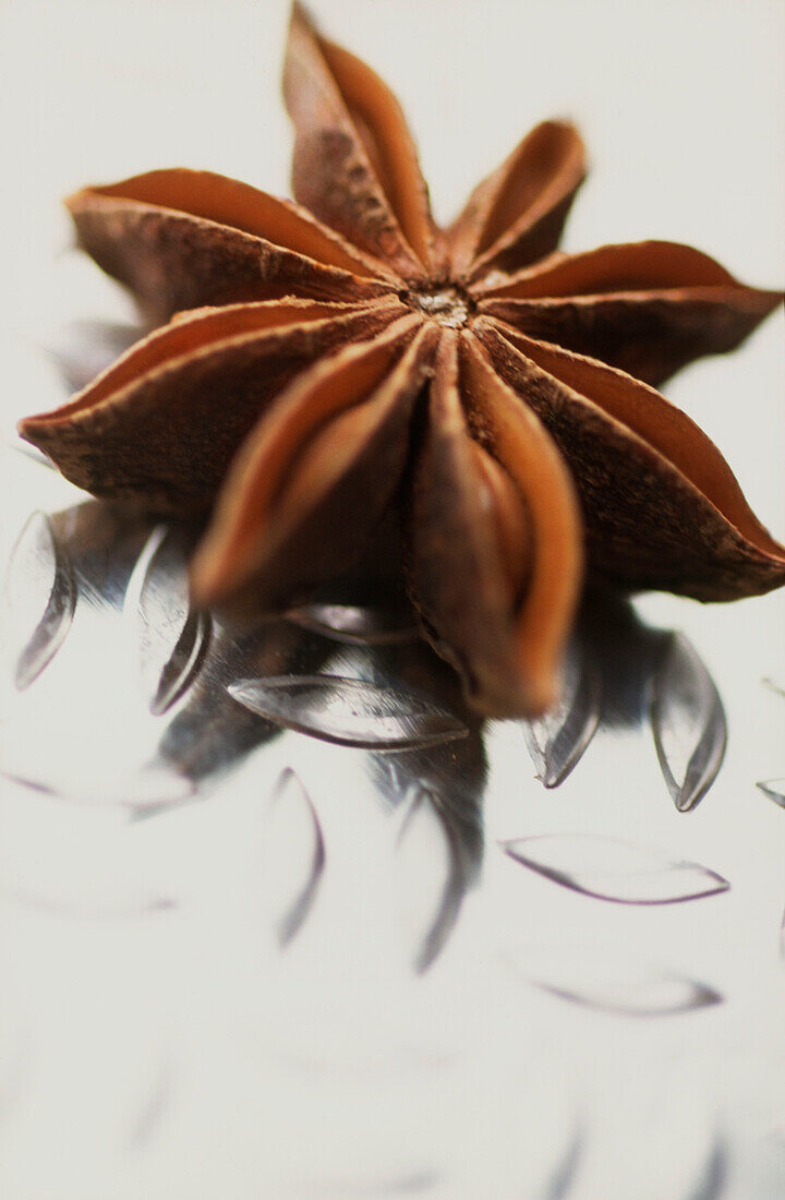 Star anise spice on a textured metal surface