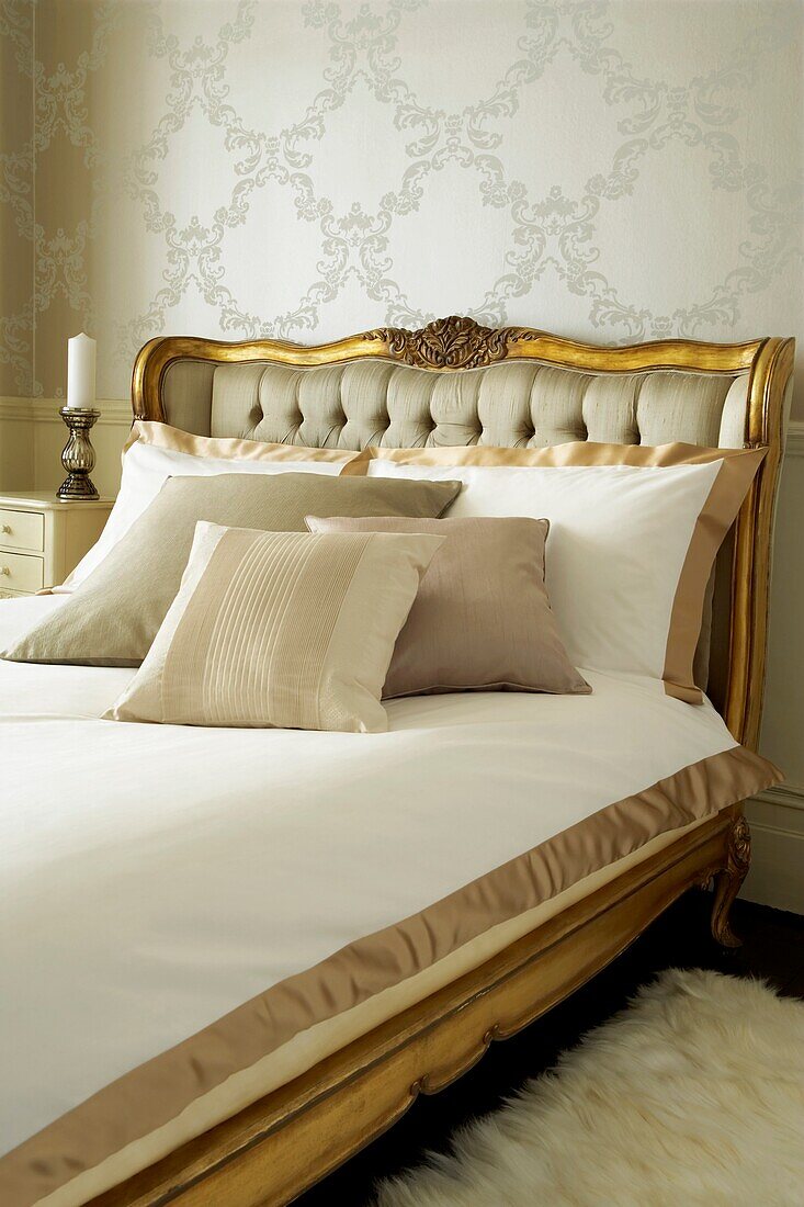 Luxurious vintage gilt bedframe with fine bed linen