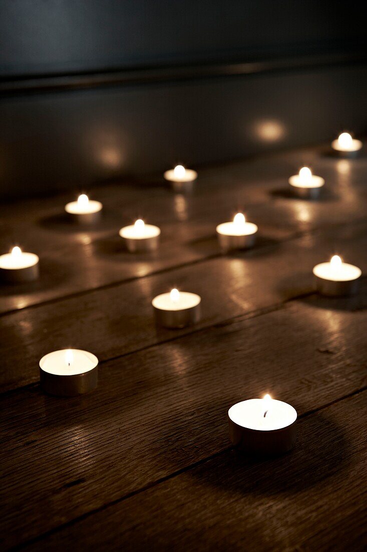 Burning candles on a wooden floor