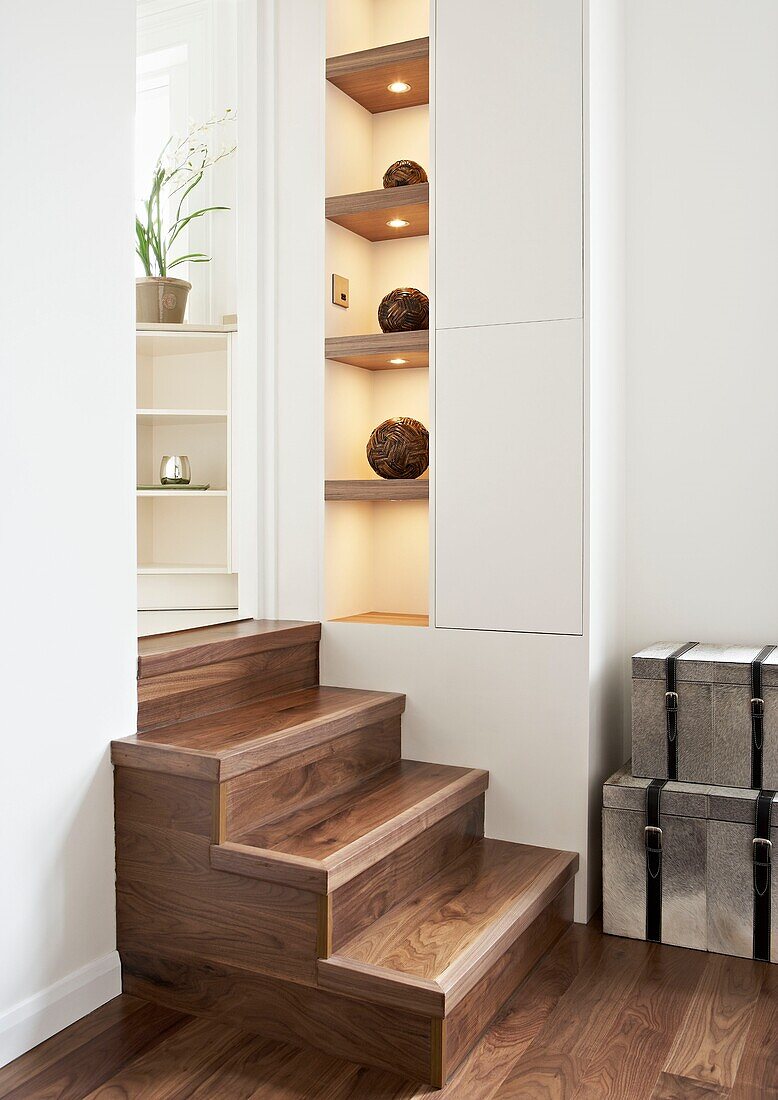Wooden steps with recessed shelving in split level London home