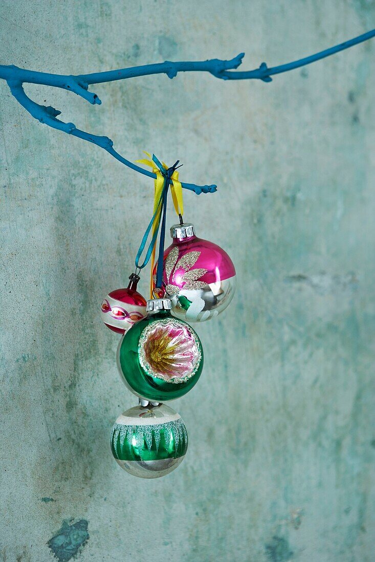 Christmas baubles hanging from a twig