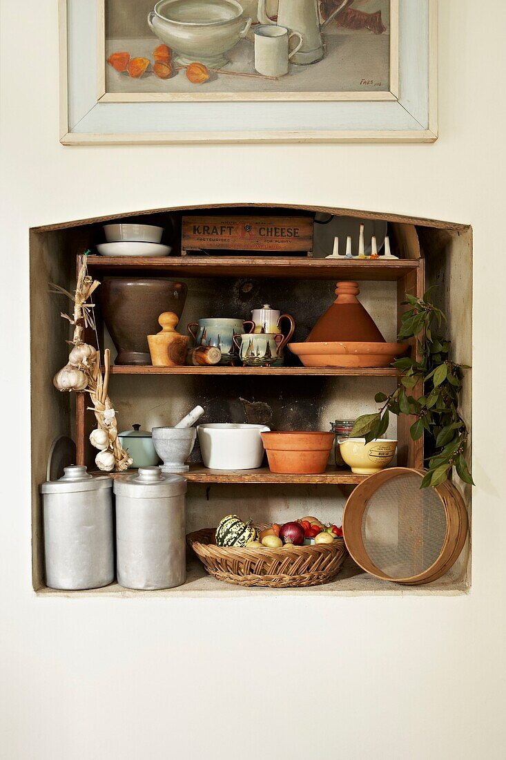 Recessed kitchen shelving   tagines and earthenware in London home   UK