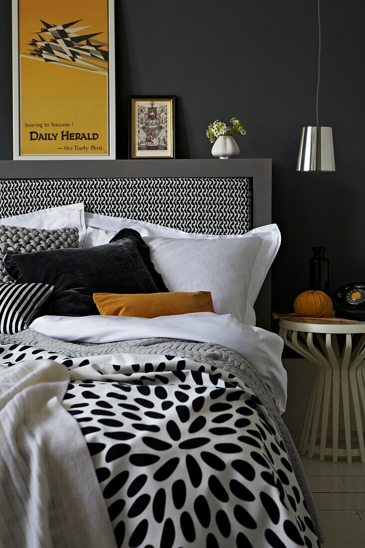 Black and white bedroom with yellow accent colours and vintage poster