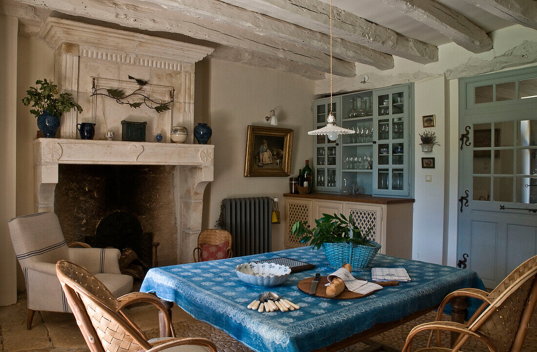 Dining room with rustic hearth and blue decor