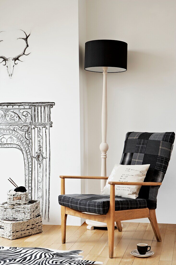 Checked retro armchair and lamp with trompe l'oeil in London home