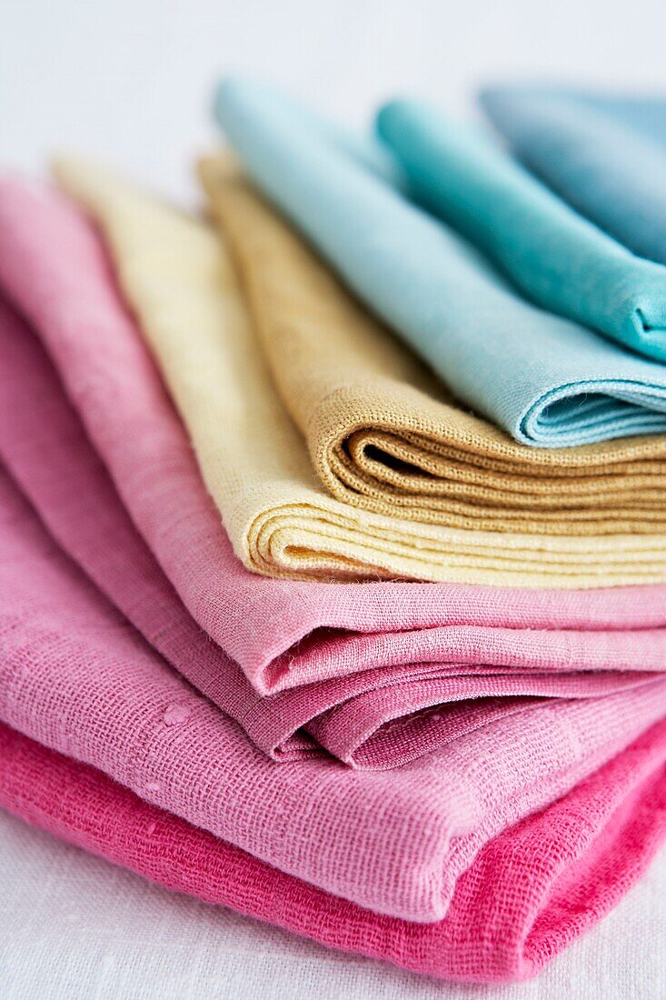 Range of coloured fabrics  folded