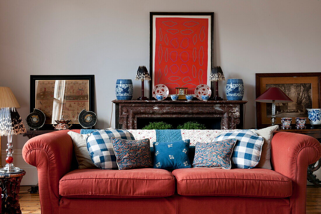 Red sofa and artwork in Greenwich home,  London,  England,  UK