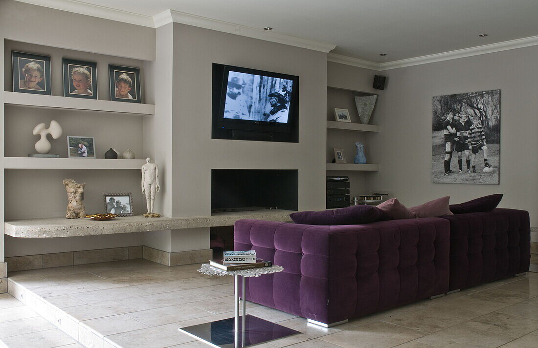 Purple sofa in home cinema of contemporary Haywards Heath home,  West Sussex,  England,  UK