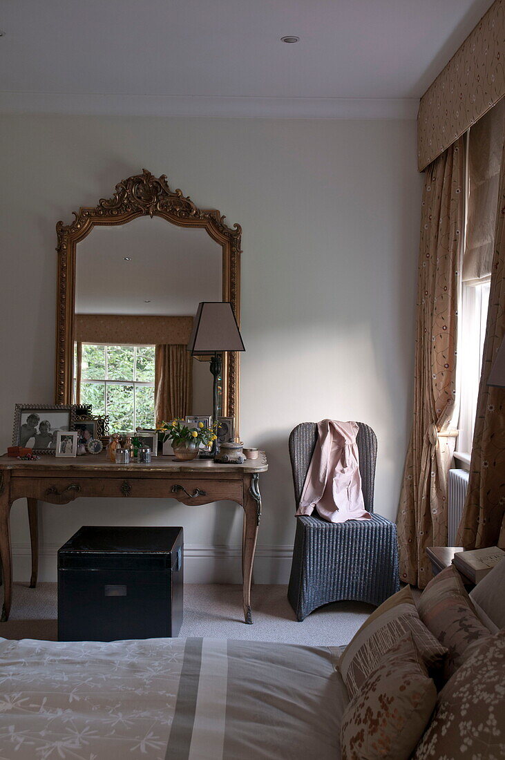 Gilt framed mirror on dressing table of contemporary Haywards Heath bedroom,  West Sussex,  England,  UK