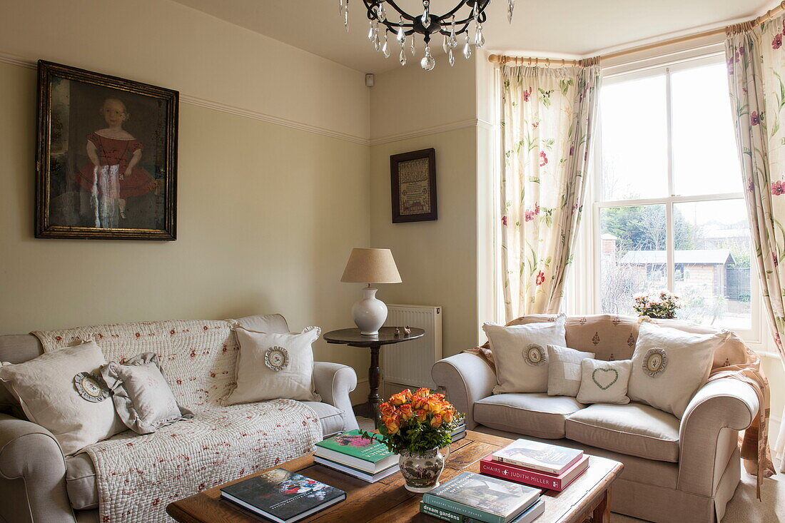 Cream sofas with wooden coffee table in living room of Ashford home,  Kent,  England,  UK