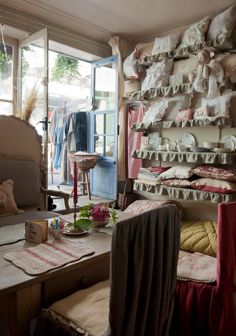 Cushions for sale in doorway of tea salon,  Dordogne,  France