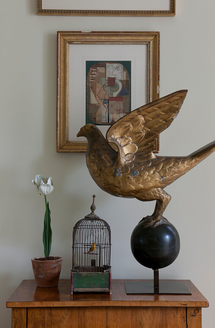 Large bird sculpture and artwork on side table in Washington DC home,  USA