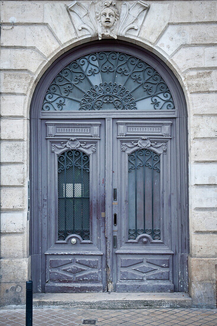 Antique arched double doorway and entrance to Bordeaux apartment building,  Aquitaine,  France