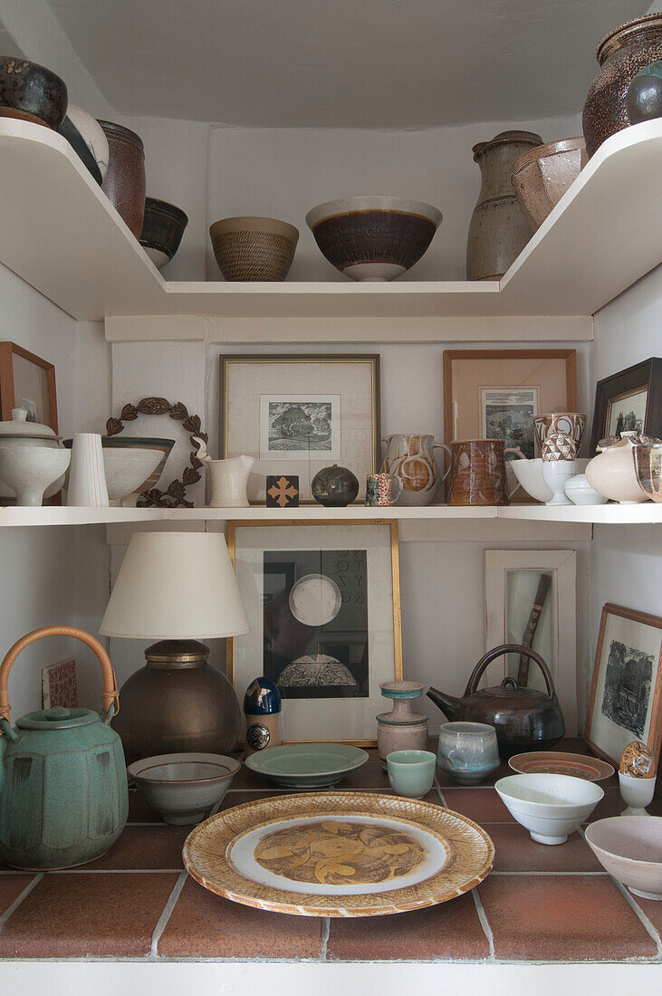Collection of pottery on recessed shelving in Dorset home  Kent  UK