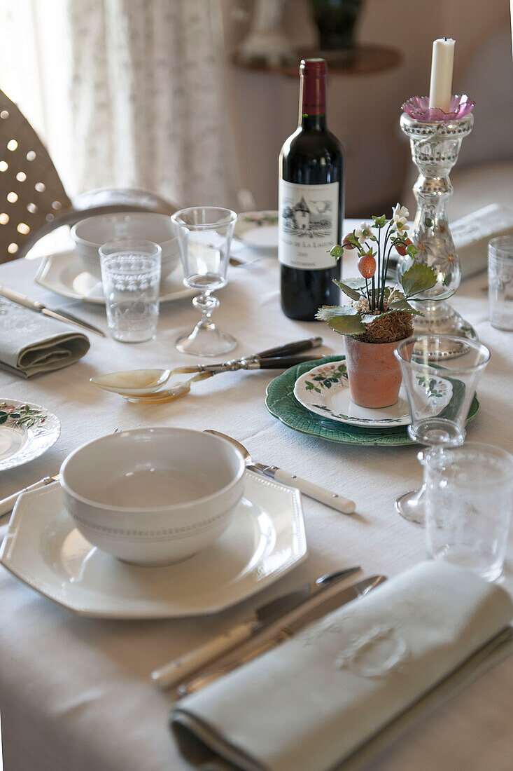 Red wine with white crockery at place setting on Dordogne cottage table  Perigueux  France