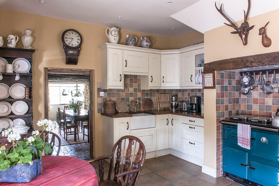 White fitted farmhouse kitchen with tiled splashback in Ashford  Kent  UK
