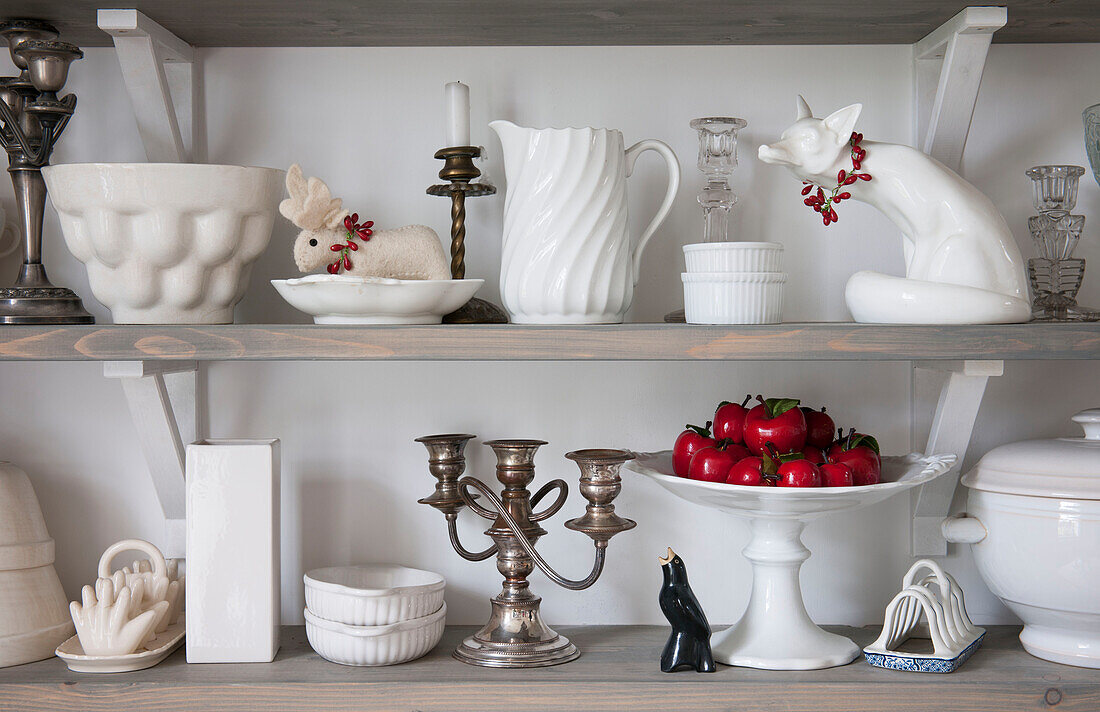 White ceramic crockery and ornaments on open shelving in London home  England  UK