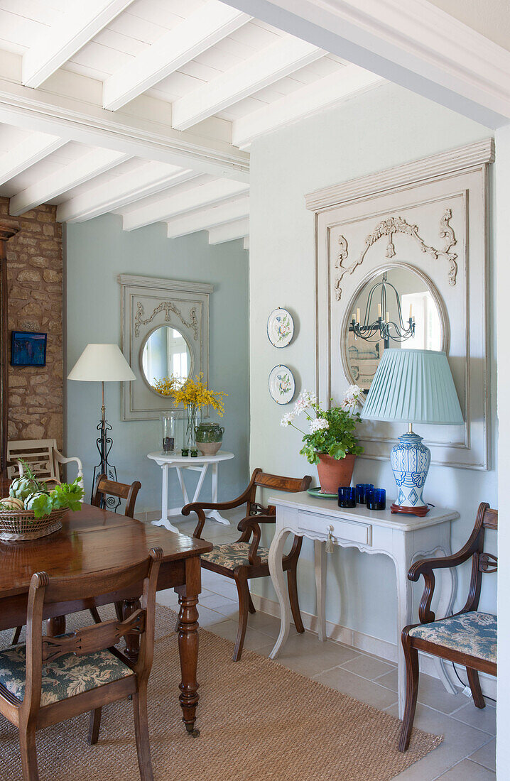 Light blue lamp and mirror with side table in dining room of Dordogne farmhouse  Perigueux  France