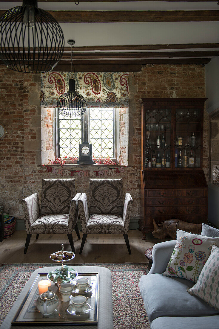 Zwei gepolsterte Stühle und ein bleiverglastes Fenster in der unter Denkmalschutz stehenden Priory Headcorn Kent UK