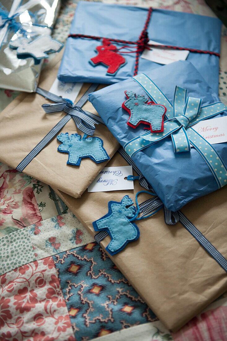 Gift wrapped presents on patchwork quilt in London home  England  UK