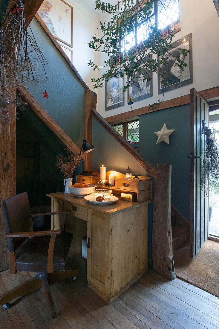 Desk and chair in teal timber framed hallway of Kilndown cottage  Kent  England  UK
