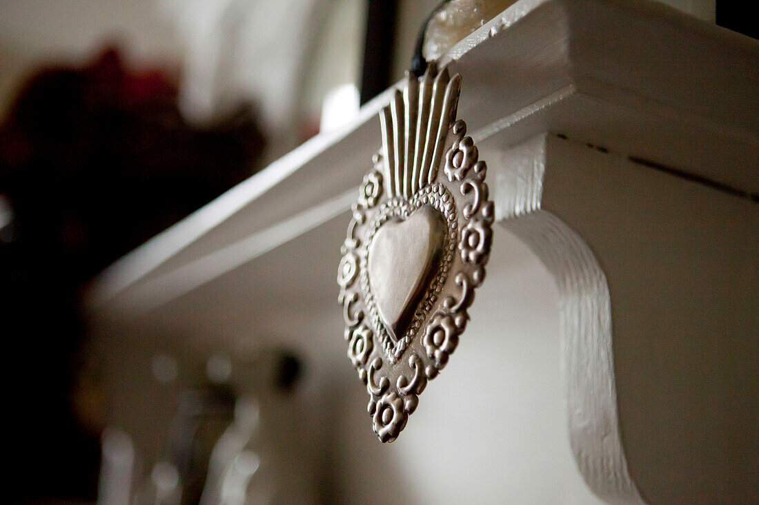 Silver metal heart on mantlepiece in Brighton home, East Sussex, England, UK