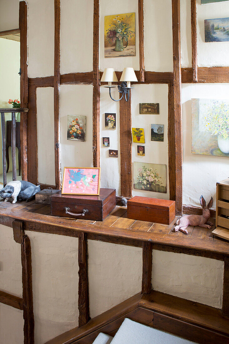 Paintings above wooden desk in Amberley cottage West Sussex UK