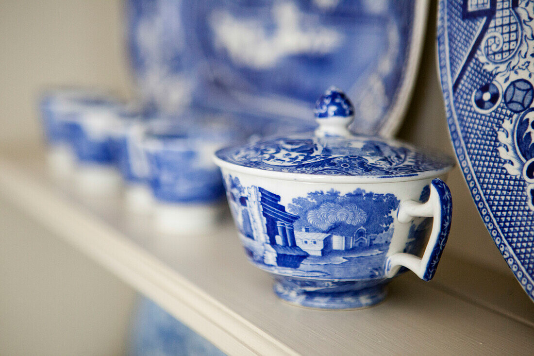 Blue and white chinaware on kitchen dresser in Amberley home West Sussex England UK