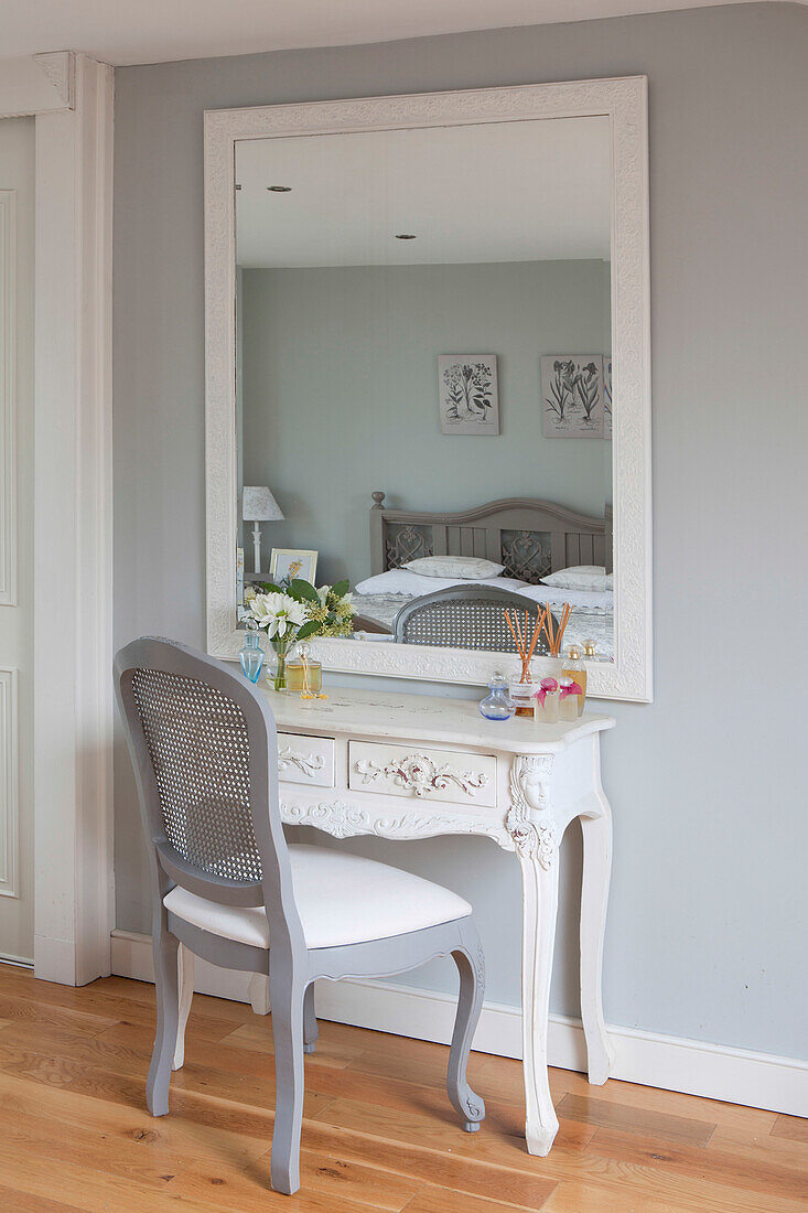 Grey painted chair at dressing table with mirror in Brighton home, East Sussex, England, UK