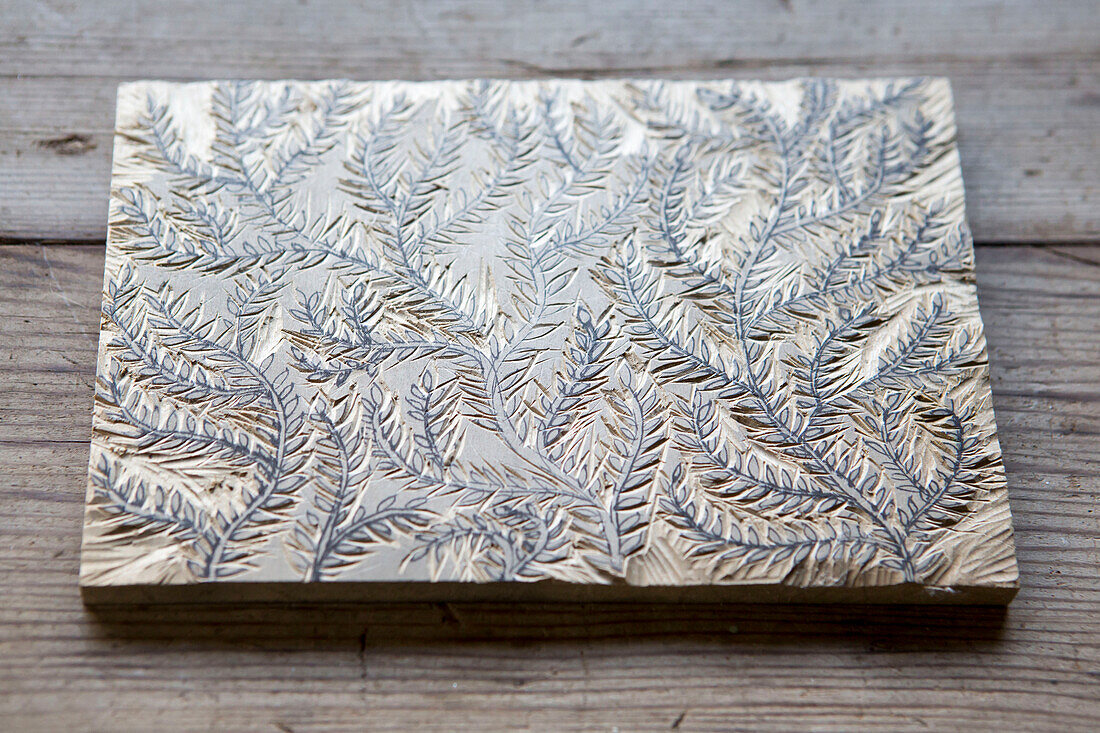 Carved foliate wooden block in artist's studio Cornwall UK