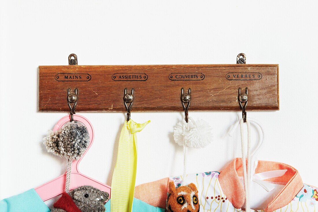 Wooden clothes hook with French text in child's nursery of London family home,  England,  UK