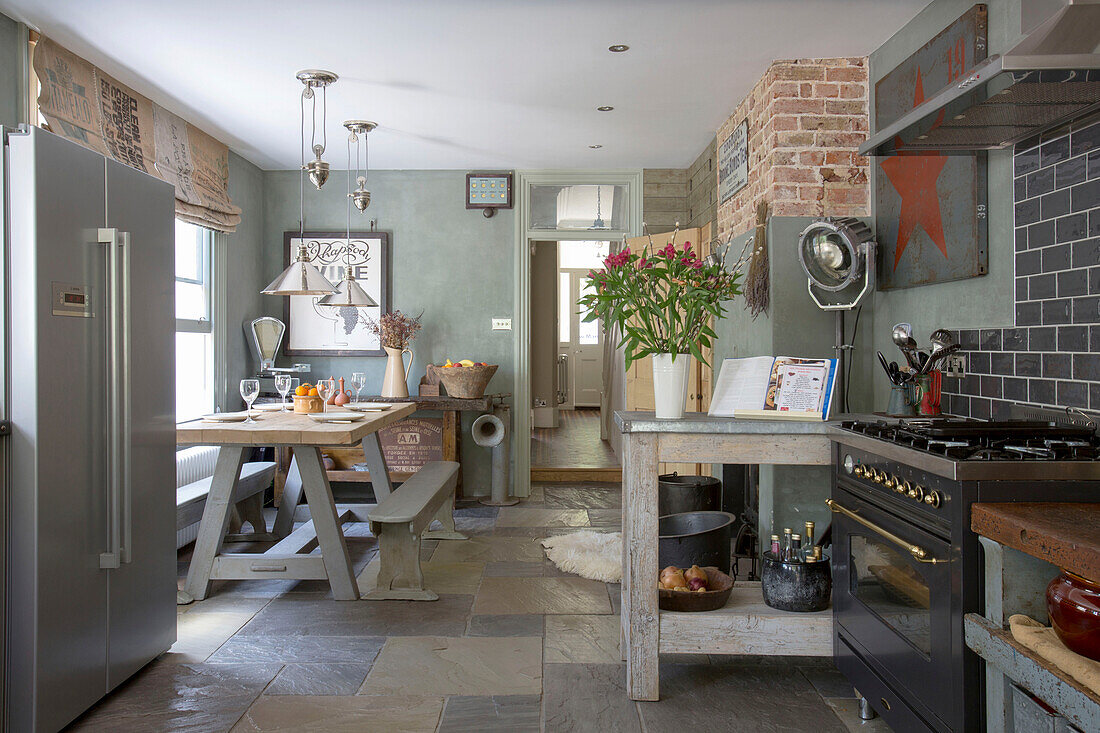 Open plan kitchen diner with salvaged floor in Edwardian West Sussex townhouse England UK