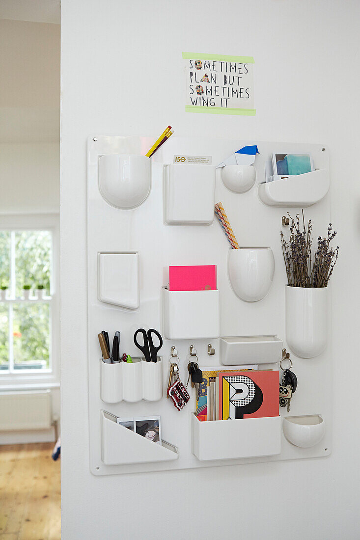 Wall-mounted stationery in kitchen of London home,  England,  UK