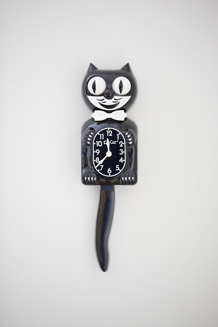 Black cat clock on white wall in Alloa home  Scotland  UK