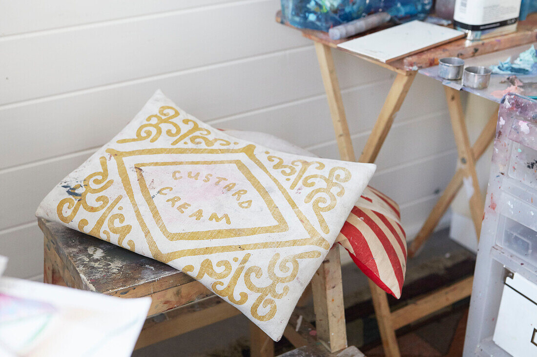 patterned 'custard cream' cushion on work stool in Alloa studio  Scotland  UK