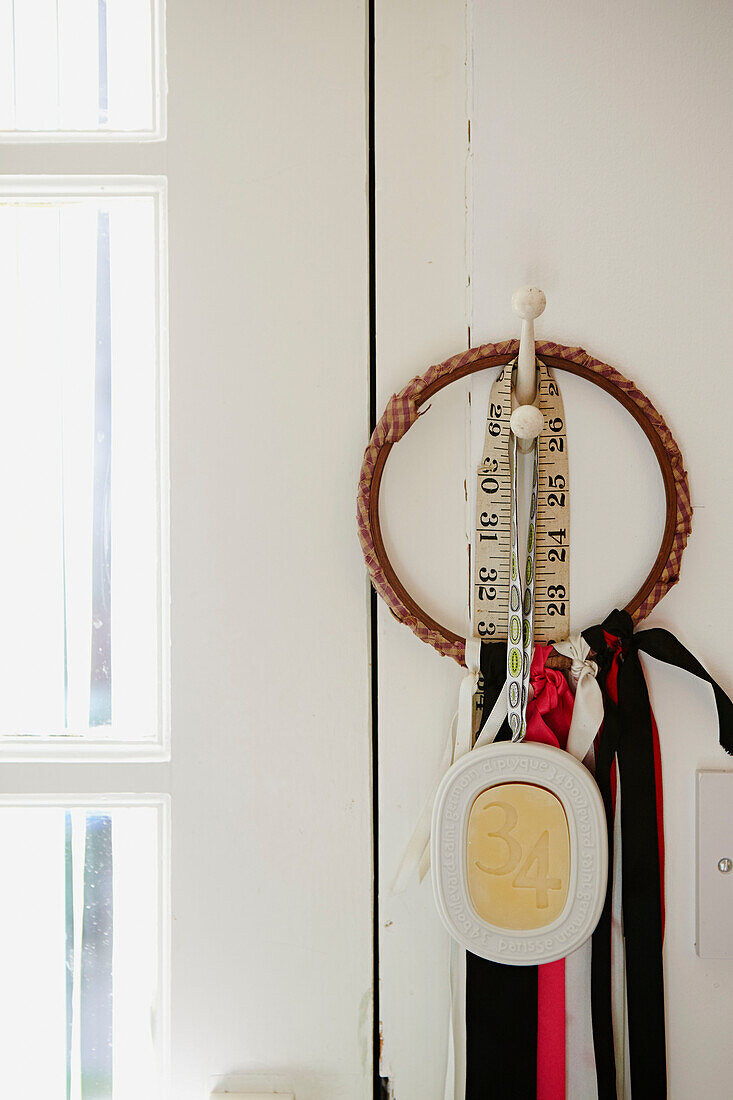 Tape measure and ribbon hang in Faversham studio,  Kent,  UK