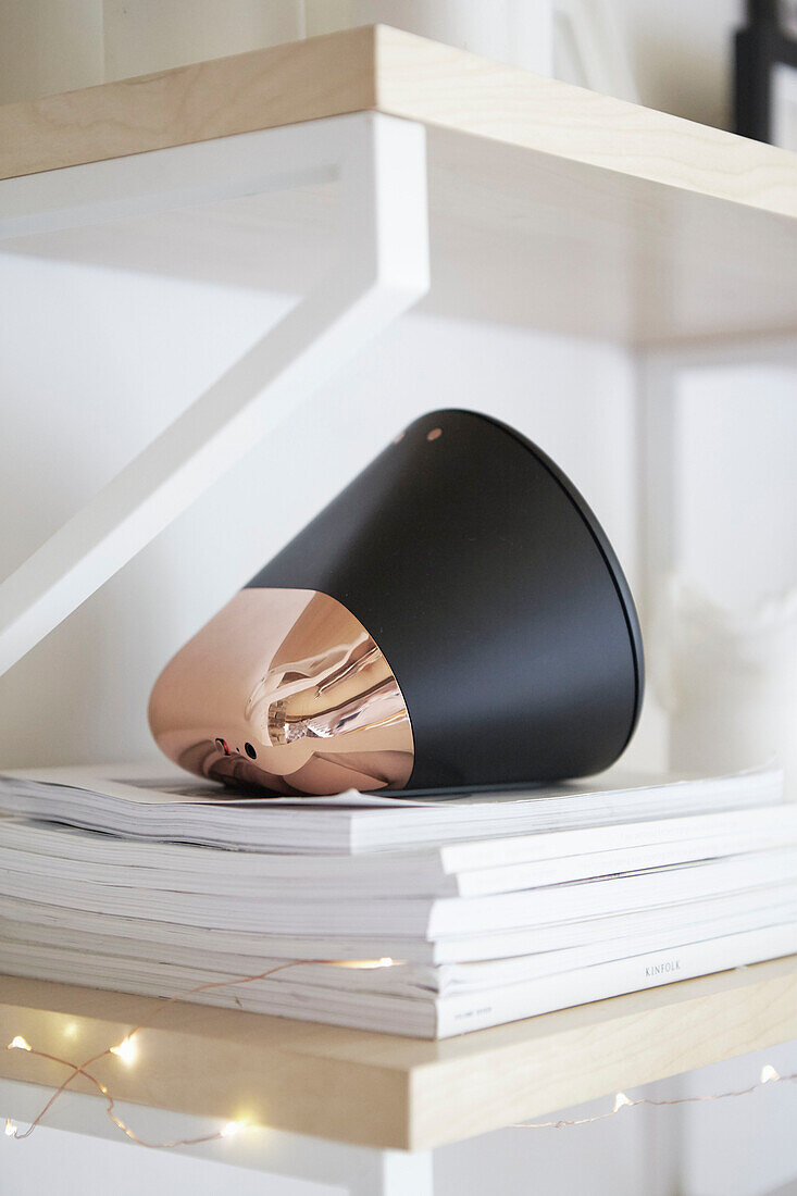 Black and copper loudspeaker on magazines in West Yorkshire home  UK