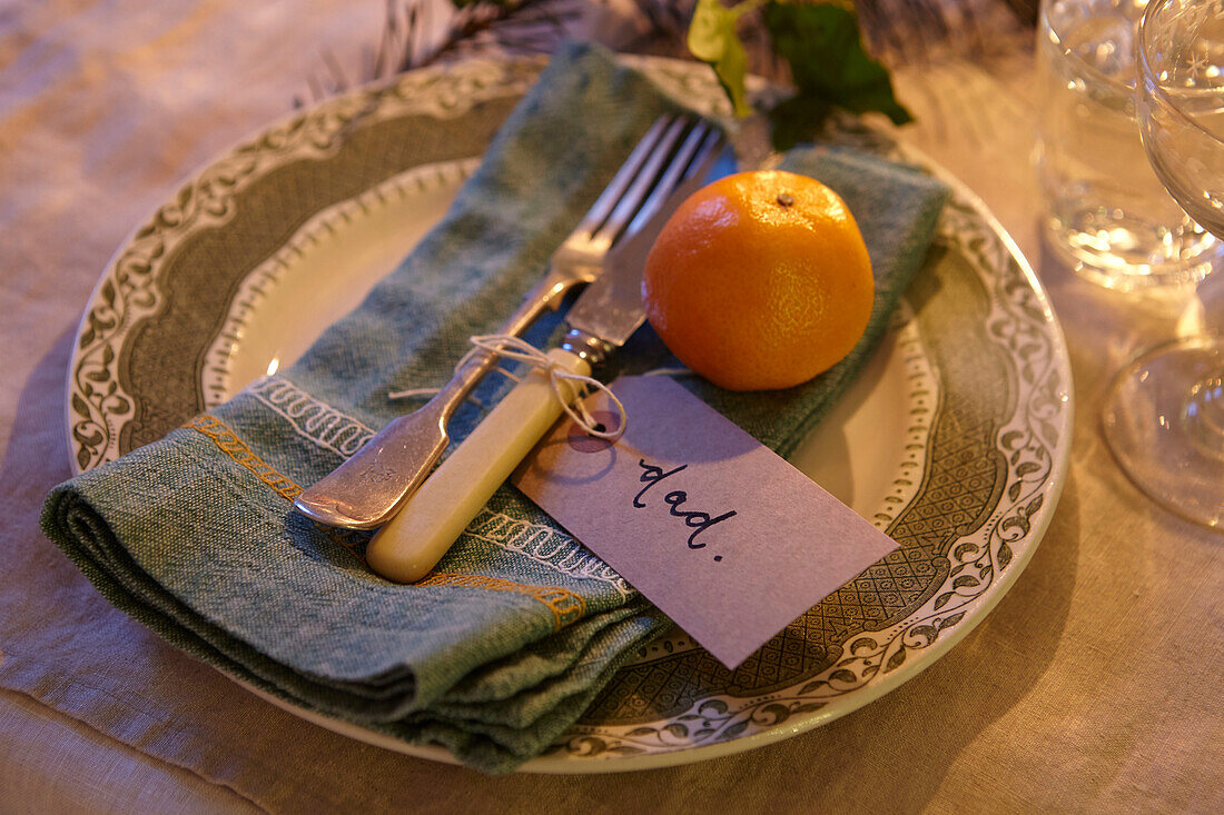 Satsuma on place setting with napkin and cutlery in London home  UK