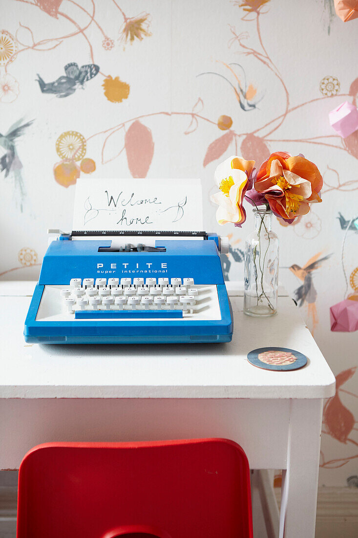 Red plastic chair at desk with typewriter  girl's room  Sheffield home  Yorkshire  UK