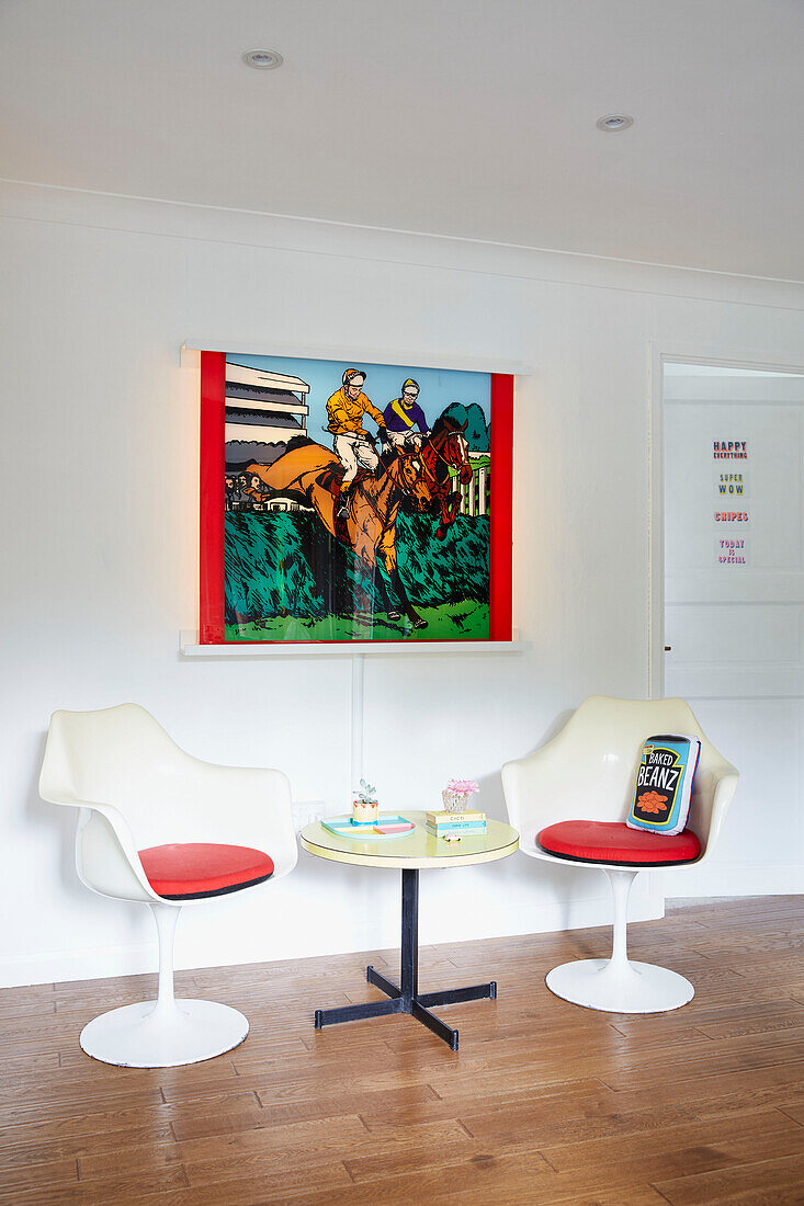 Pair of chairs and colourful artwork in York home  England  UK