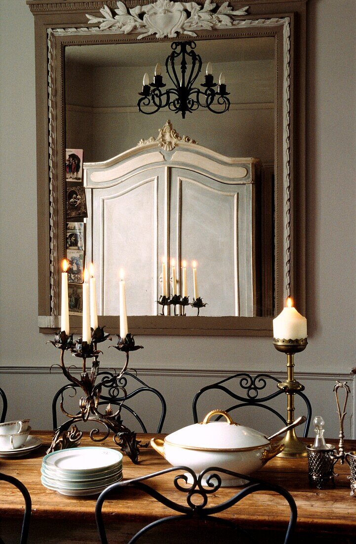 Painted French armoire reflected in dining room mirror