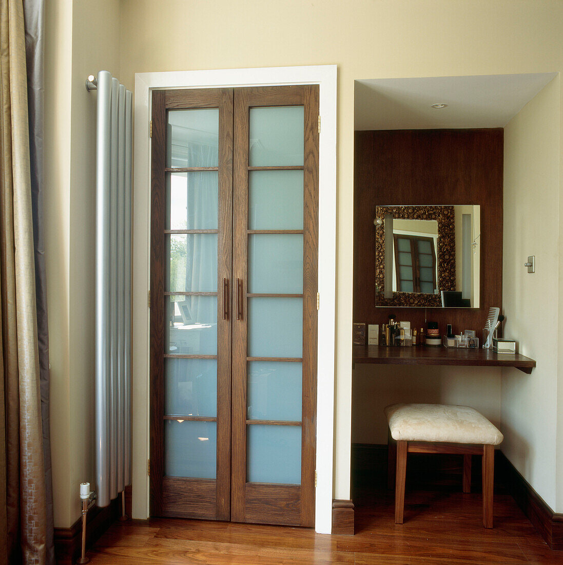 En suite bathroom in dark walnut with bespoke dressing table and double doors