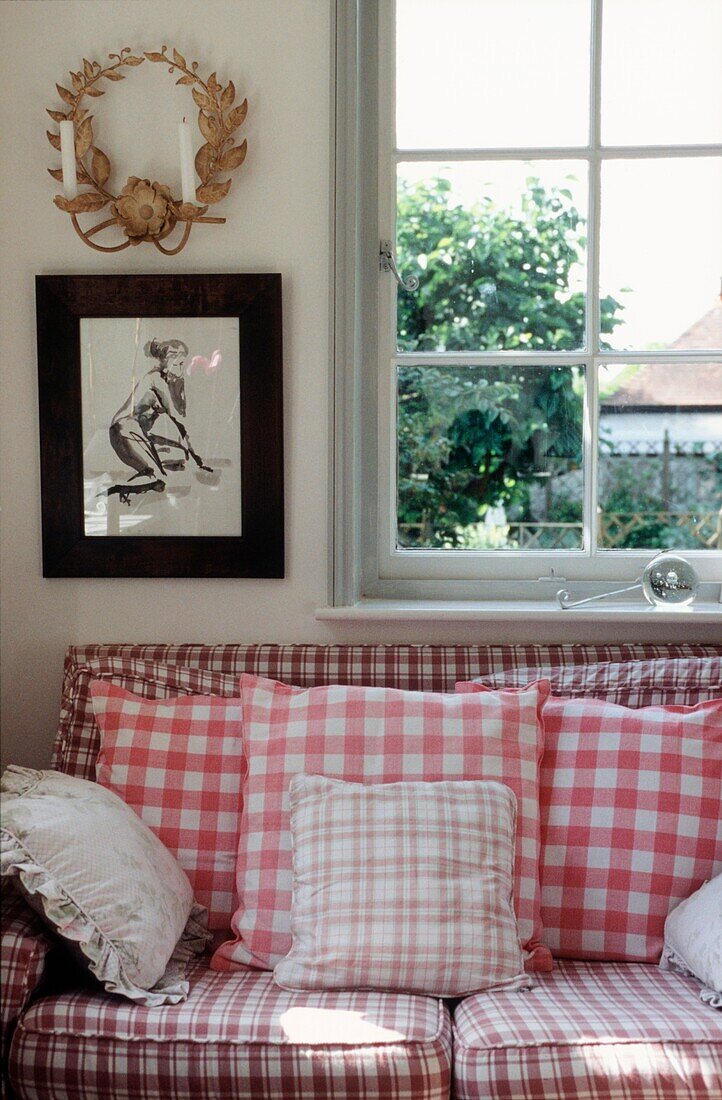 Detail of gingham sofa and window in living room