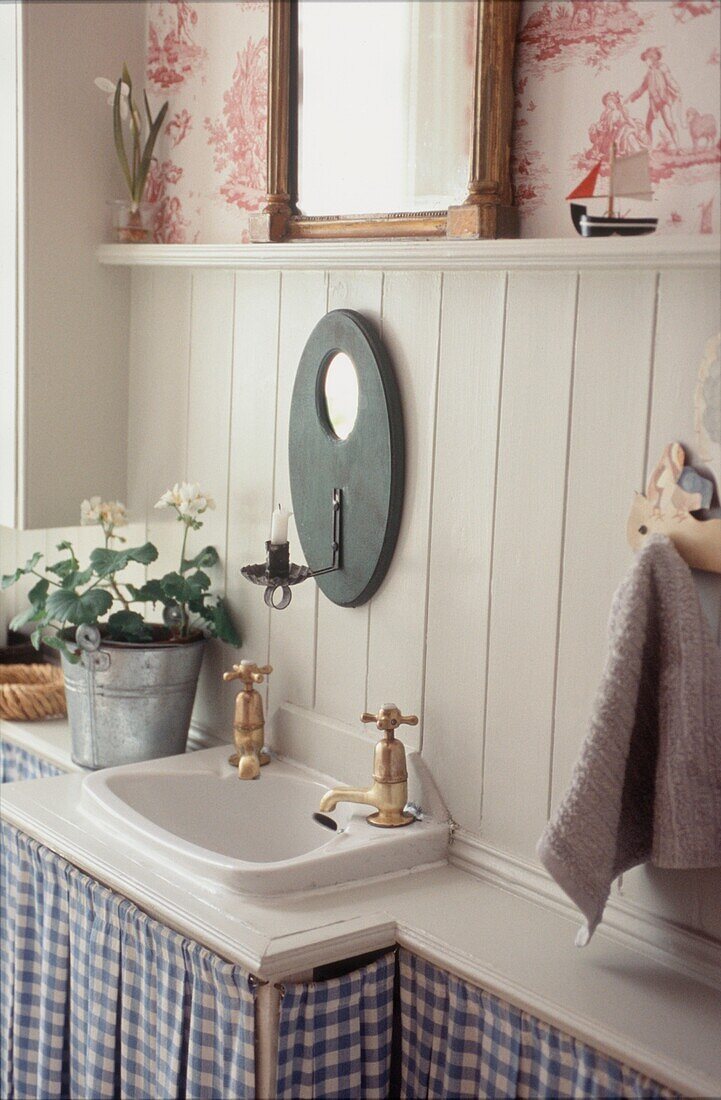 Country style Cloakroom with small sink and painted wood paneled walls 