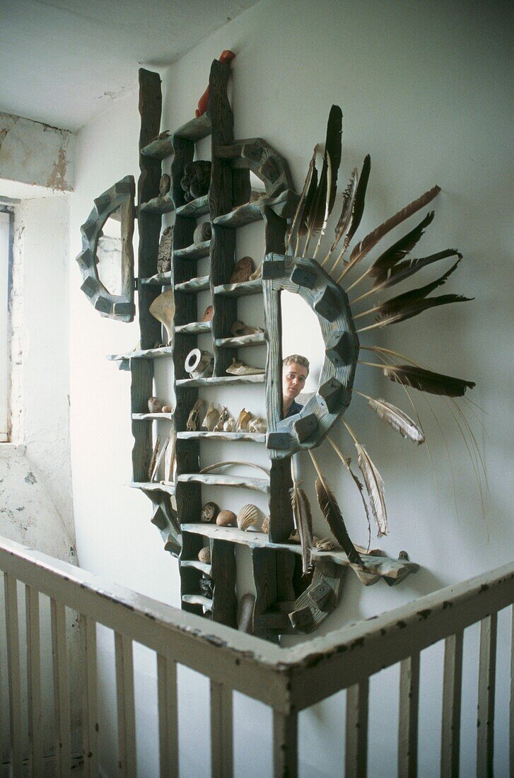 Sculptural one off mirror piece in wood with reflection of man
