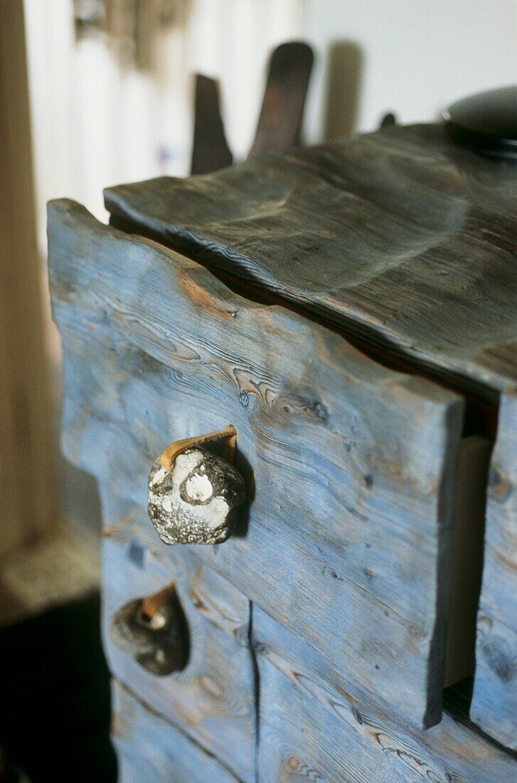 Close up of drawer front in blue stained wood 